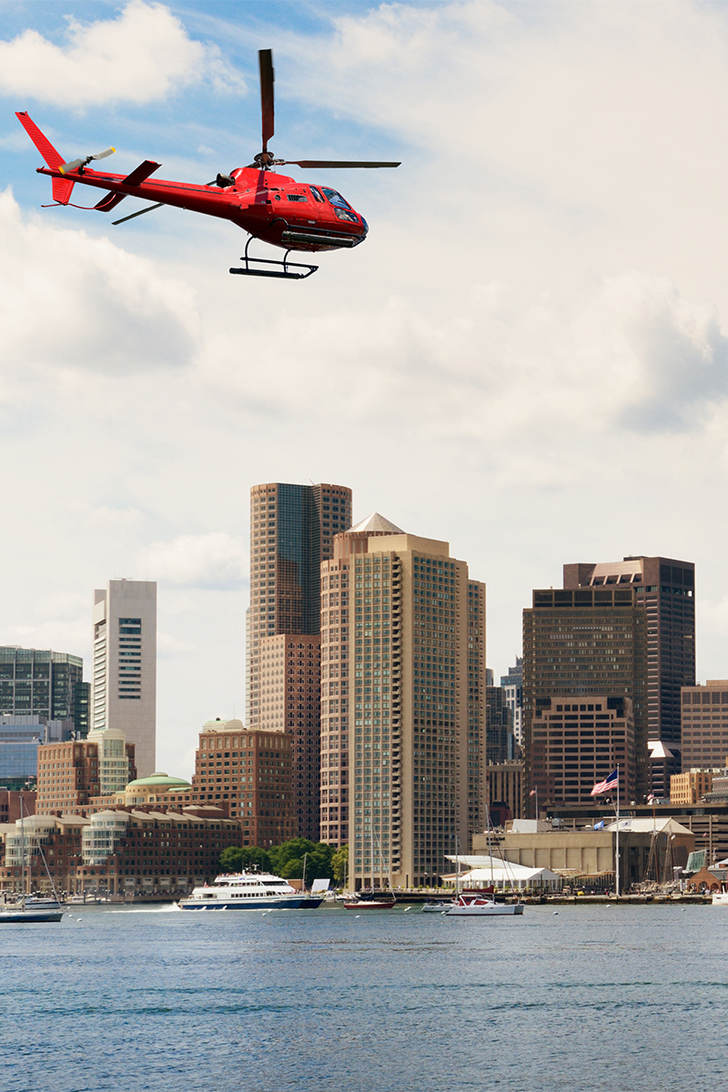 Helicopter flying over Boston skyline