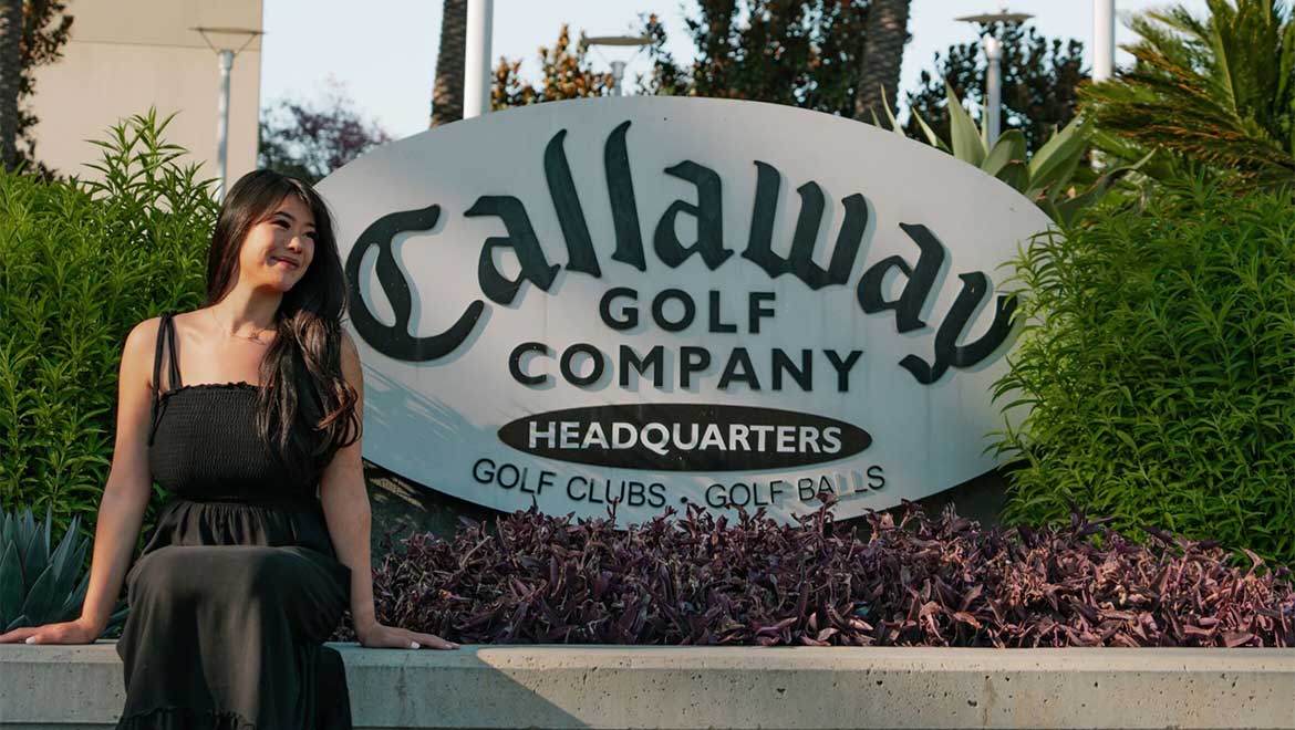 Woman sitting in front of Callaway sign