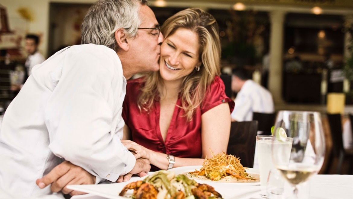 Man kissing woman on cheek