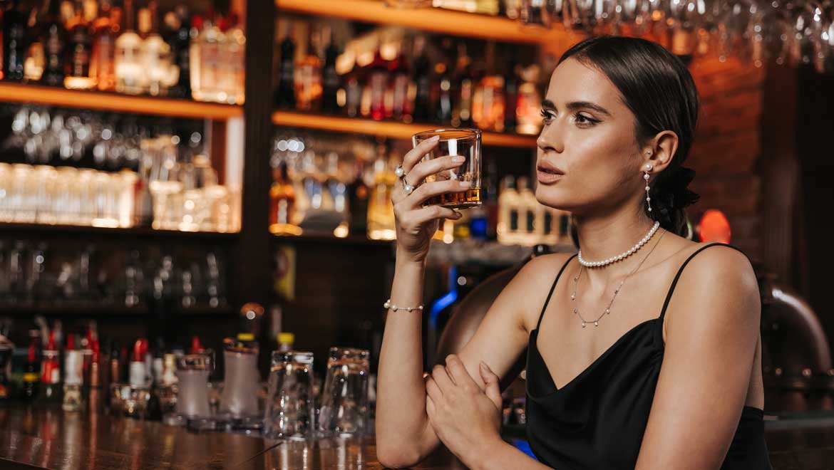 Woman drinking bourbon.