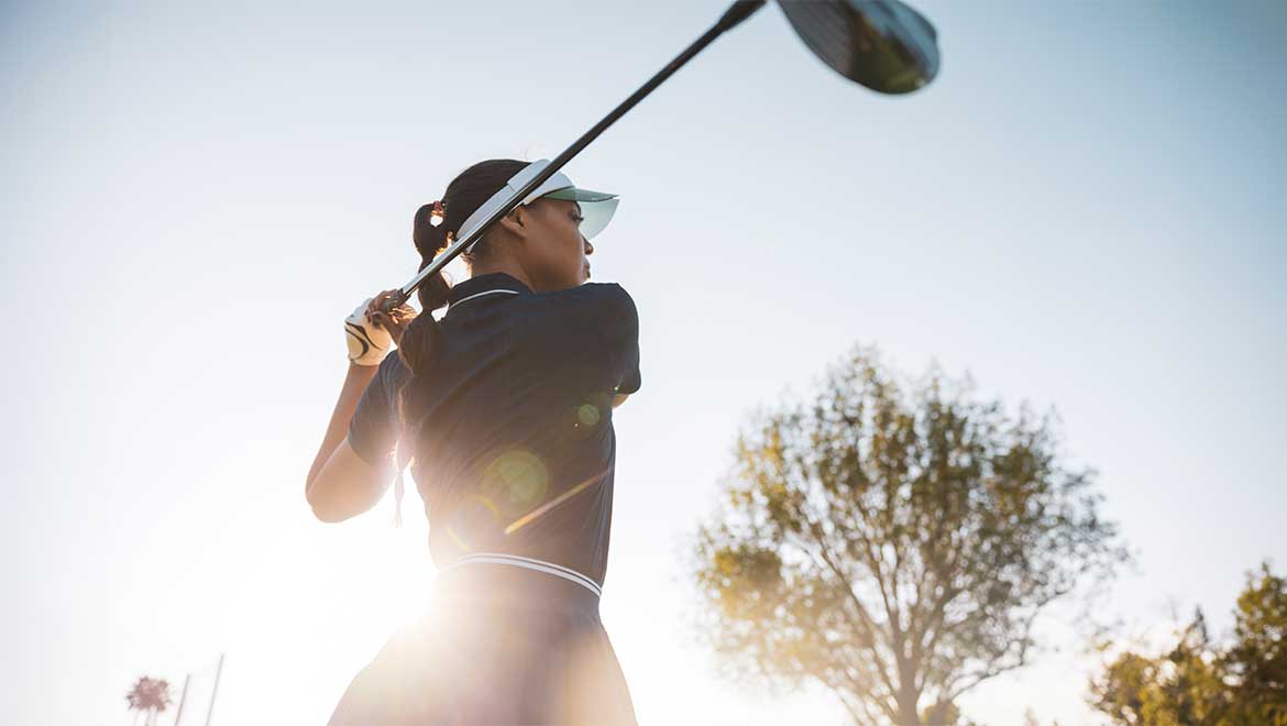 Woman hitting a golf ball