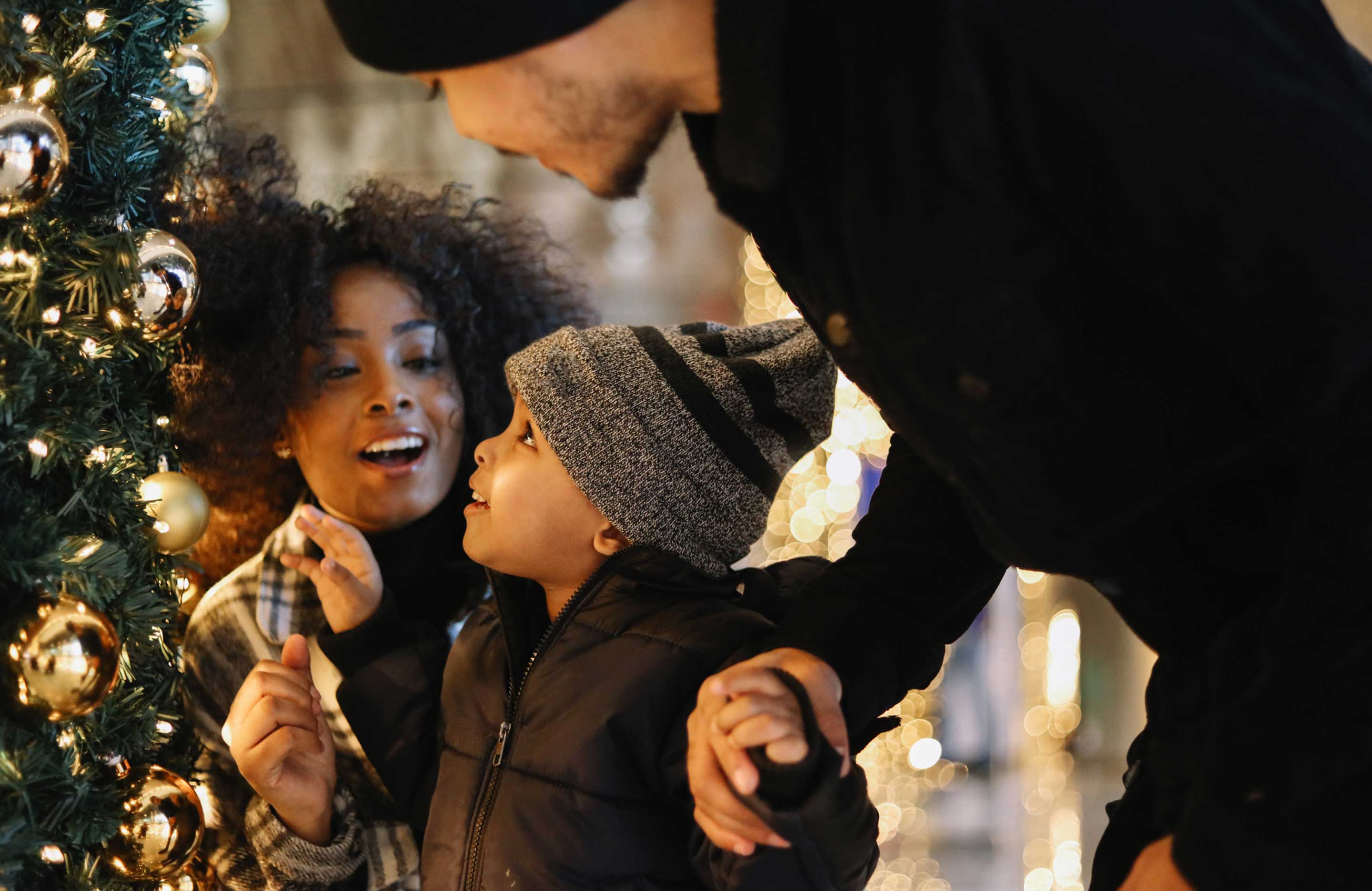 Family looking at beautiful Christmas tree.