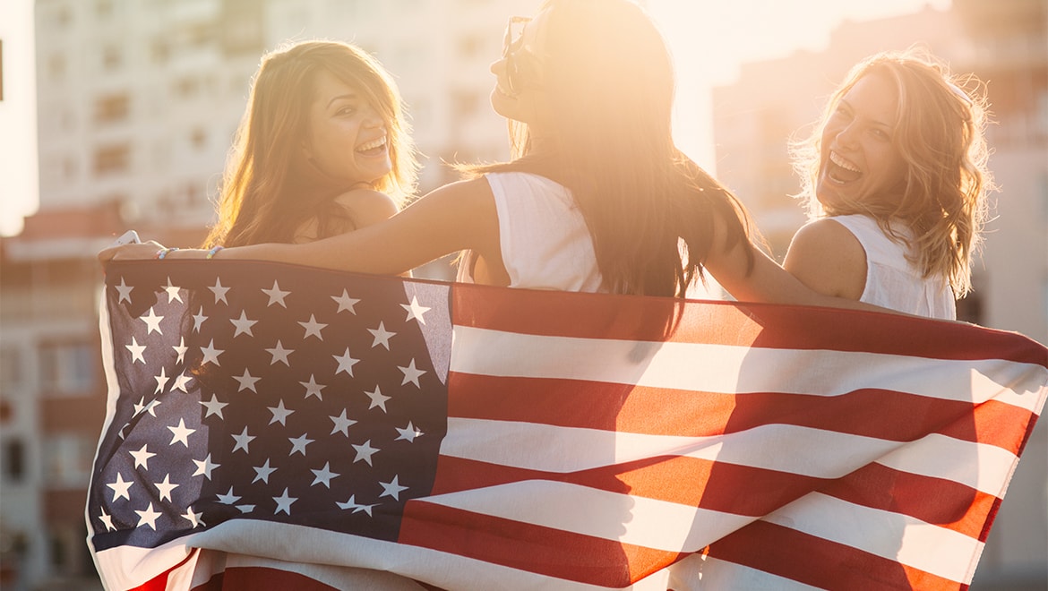 Three ladies with American Flag.