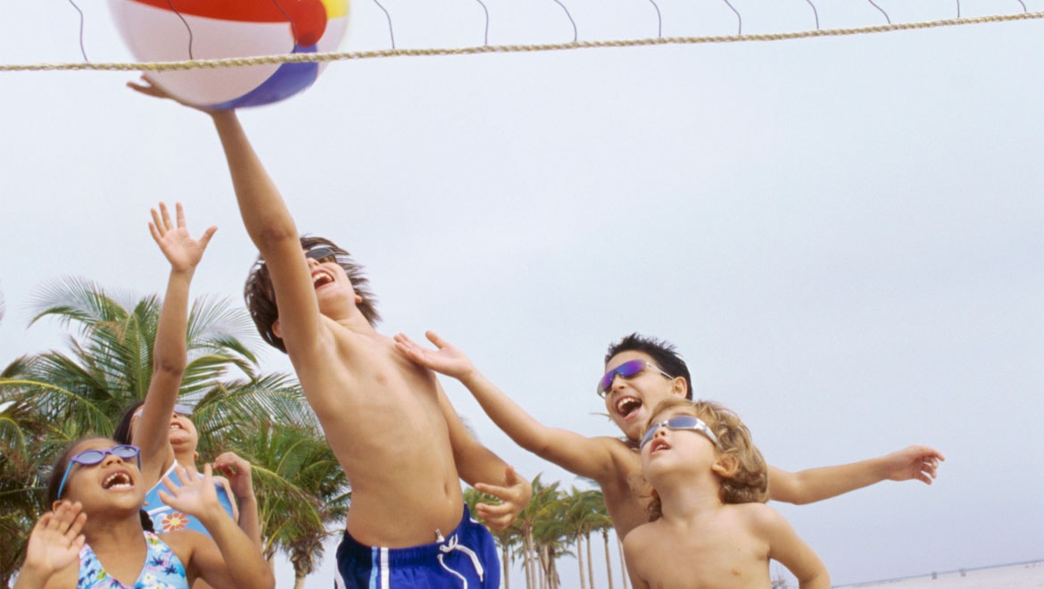 Kids playing beach volleyball