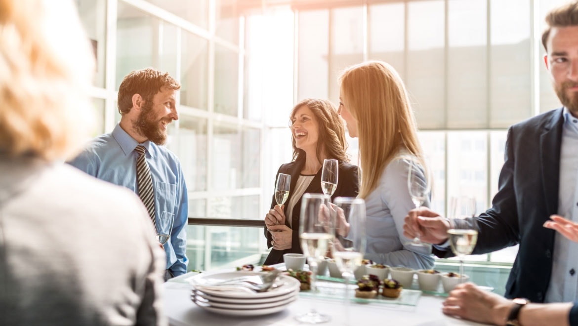 Group of people socializing at a networking event 