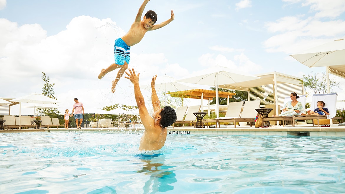 Dad playing with child in pool