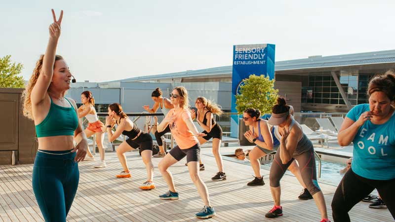 People attending Kick It fitness class on the rooftop of Omni Boston Seaport