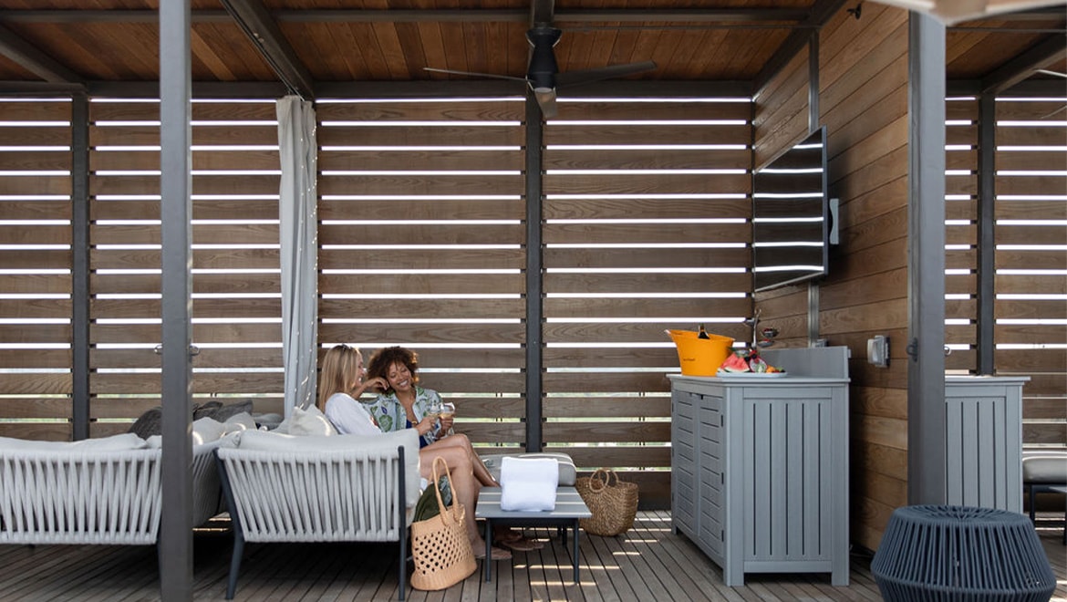 women in rooftop cabanas