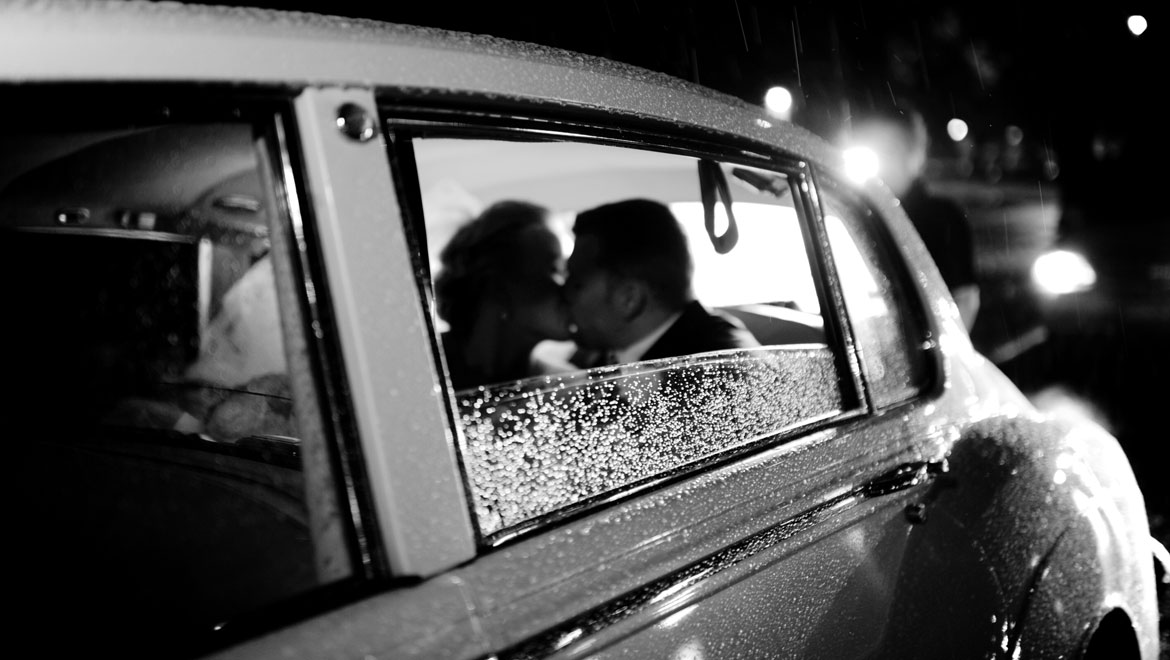 Bride and groom in getaway car