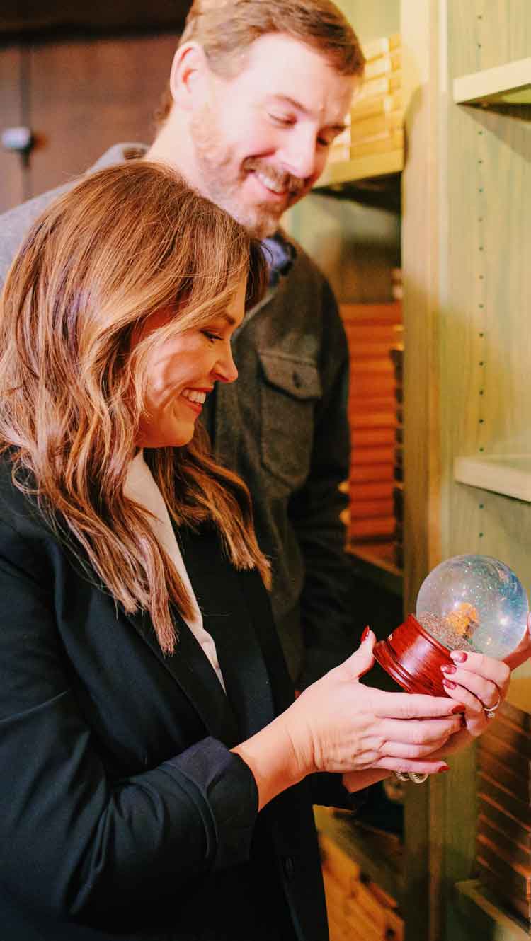 Couple looking at a snowglobe