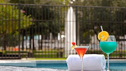 Drinks and towel by the pool at Houston Westside hotel 
