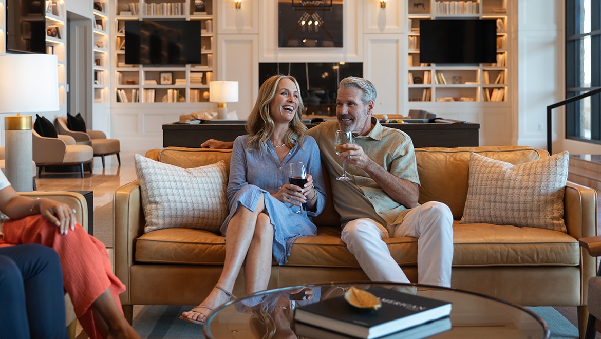 Couple sitting on couch with a glass of wine