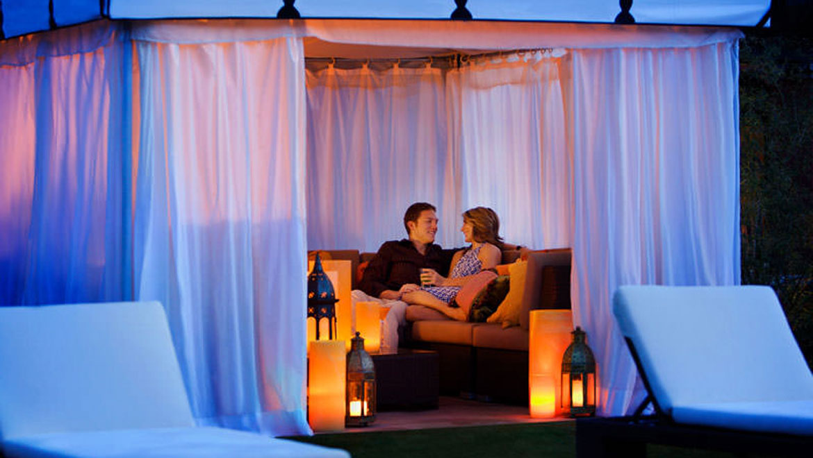 Couple in cabana at the pool in Scottsdale 