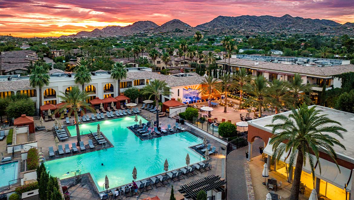 View of hotel pool during sunset 