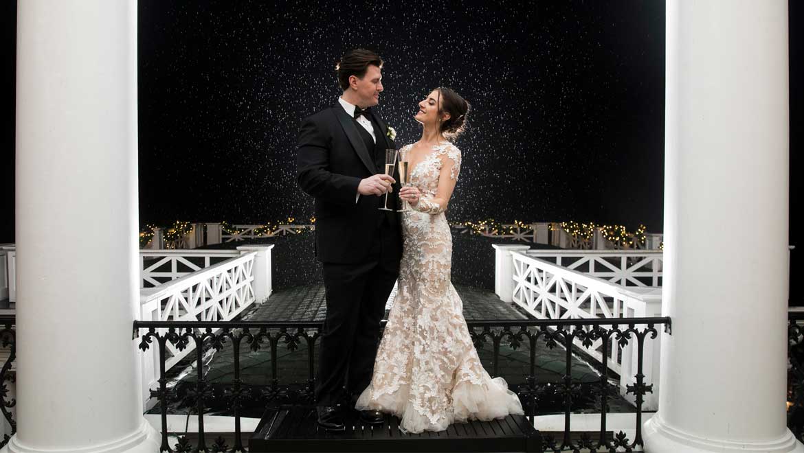 Married couple toasting on balcony