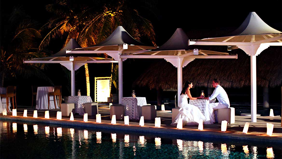 Bride and groom by pool