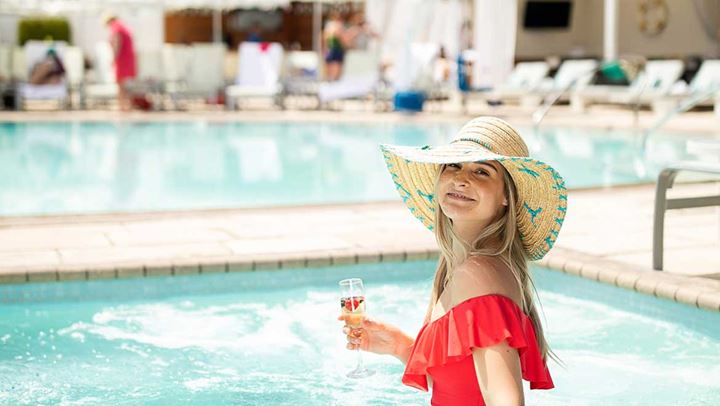 woman in pool with champagne flute