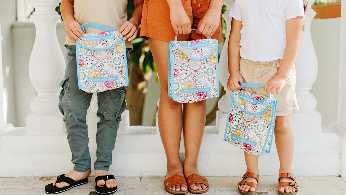 Kids holding lunch bags