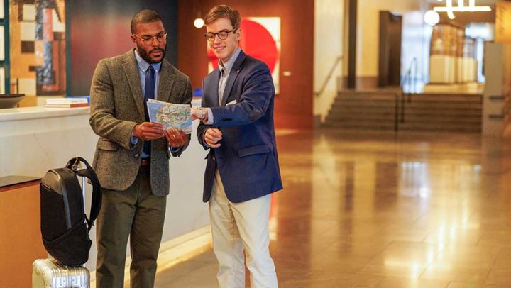 Man helping guest with directions