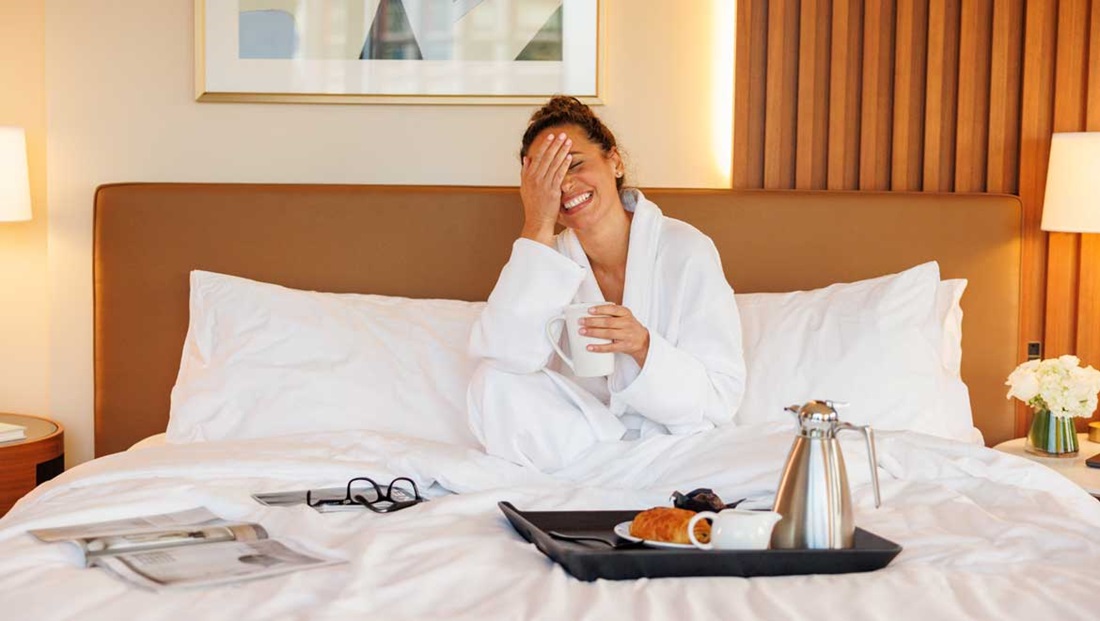 Woman eating breakfast in bed.